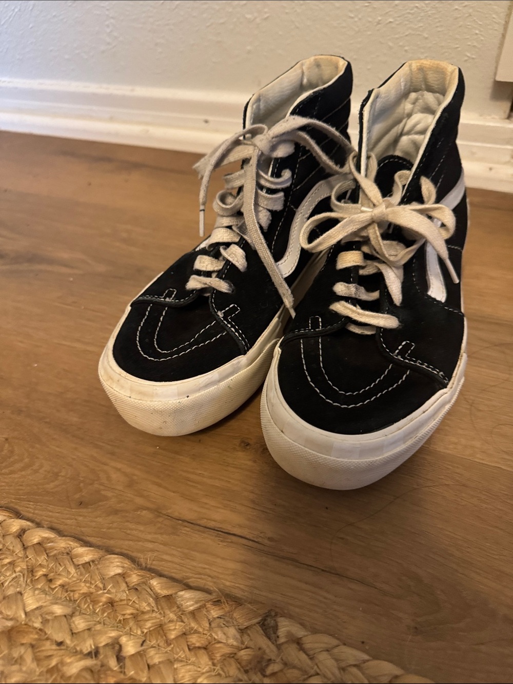 Vans women’s Black and White High-Top Skate Sneakers